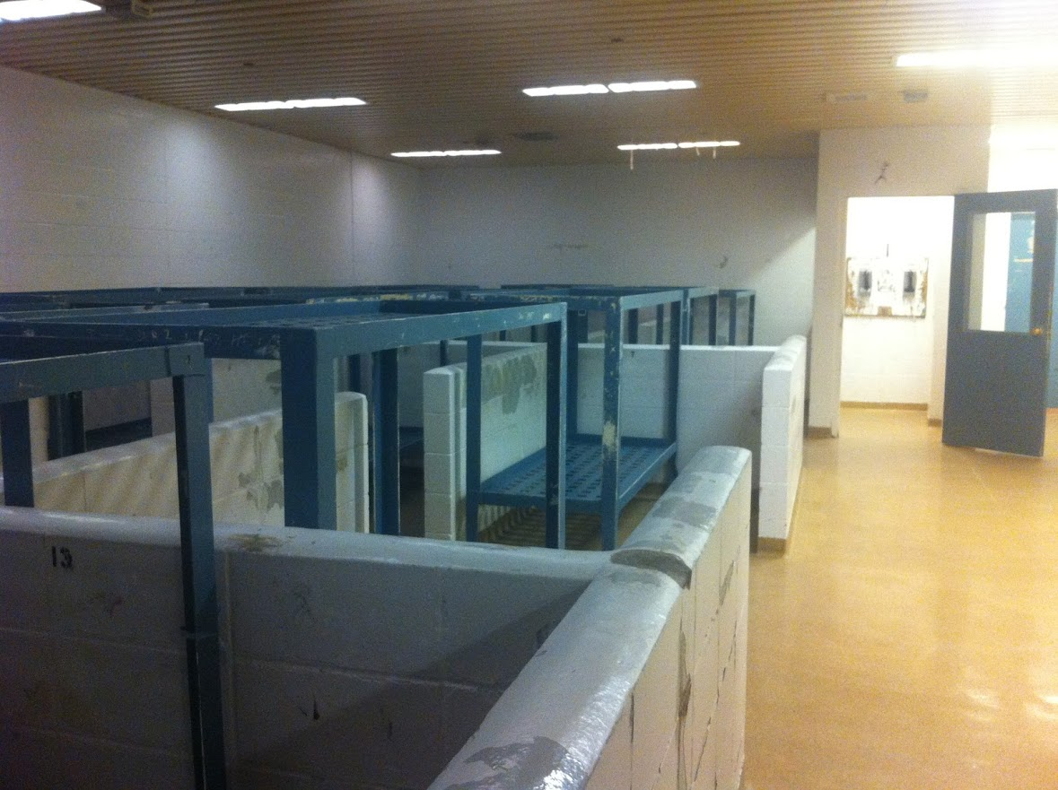 The inside of the old Edmonton Remand Centre. Worn down paint on the walls of cramped sleeping quarters with several double-bunk beds