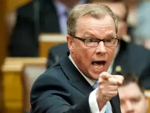 Brad Wall yelling and pointing a finger at the camera